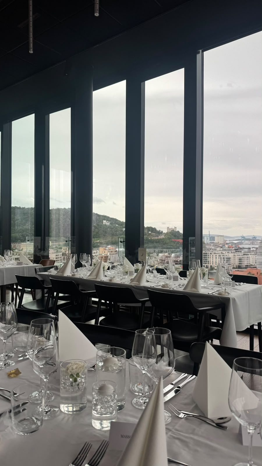 Wedding table setting beside tall windows
