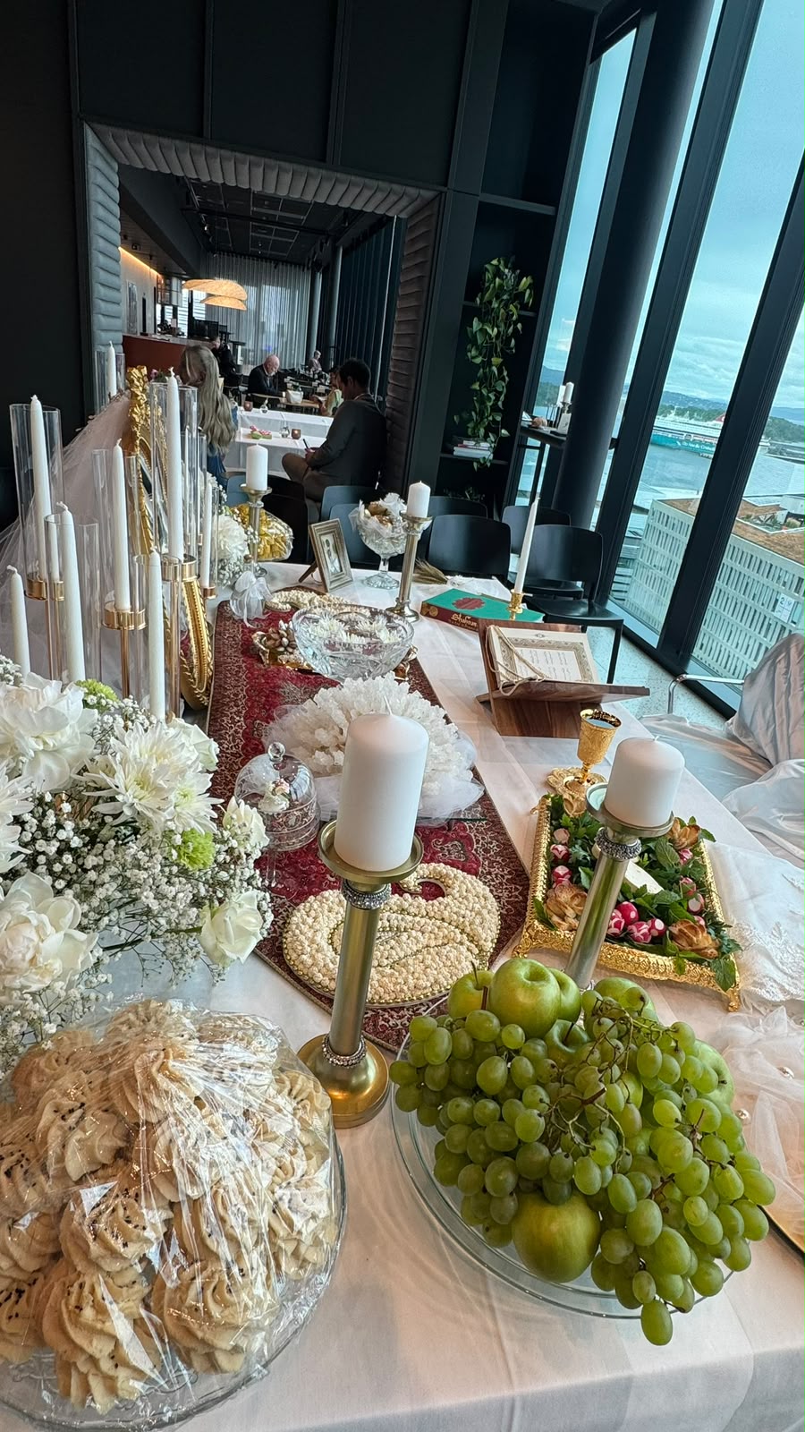 Ceremony table with flowers, candles and fruit