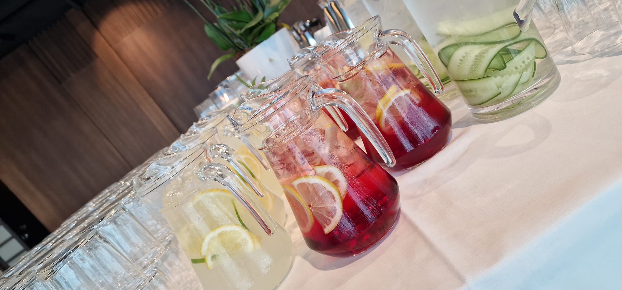Citrus and berry drinks in glass pitchers